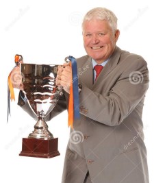 successful-mature-businessman-holding-trophy-14651465